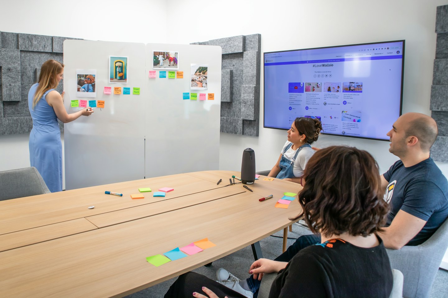 Business team brainstorms ideas in a modern office meeting room.